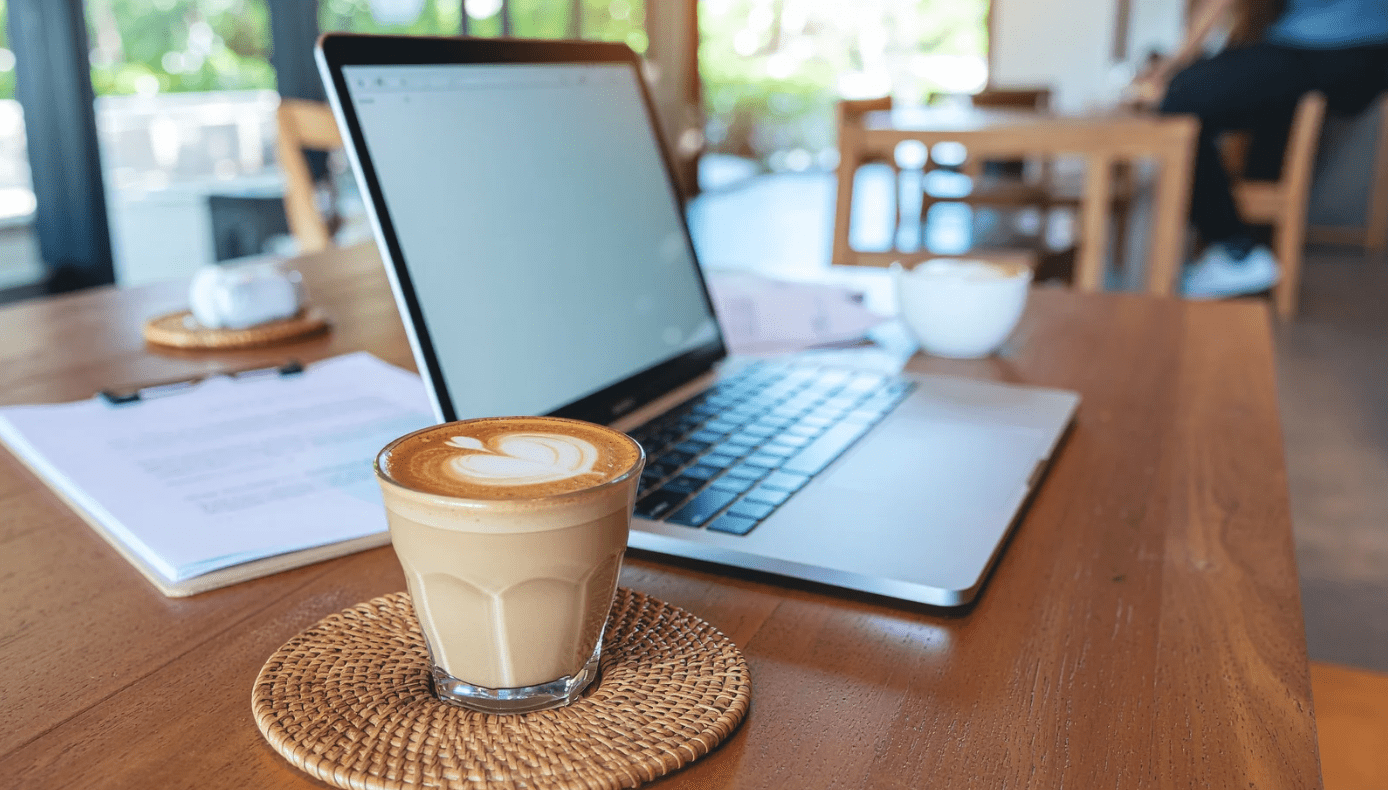 Portátil y café sobre una mesa, un espacio de trabajo que refleja hábitos y organización